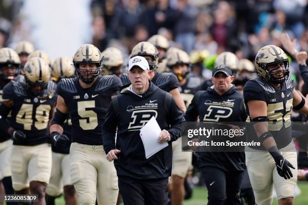 Purdue Boilermakers head coach Jeff Brohm leads his team to the field prior to a college football game against the Wisconsin Badgers on Oct. 23, 2021...