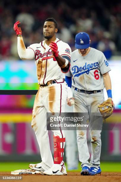 Jorge Soler of the Atlanta Braves reacts to hitting a double in the ninth inning during Game 6 of the NLCS between the Los Angeles Dodgers and the...