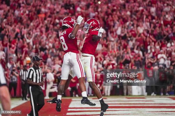 John Metchie III of the Alabama Crimson Tide and Jameson Williams of the Alabama Crimson Tide celebrate after Metchie scores in the second half at...