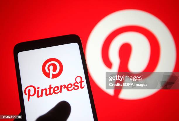 In this photo illustration a Pinterest logo of an image sharing and social media service is seen on a smartphone.