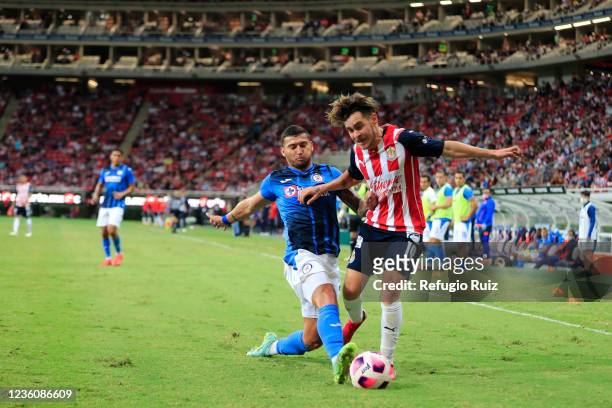 Jesús Angulo of Chivas fights for the ball with Juan Escobar of Cruz Azul during the 15th round match between Chivas and Cru Azul as part of the...