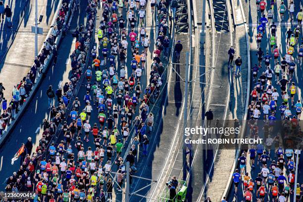 Runners participate in the fortieth edition of the Rotterdam Marathon as they cross the Erasmus Bridge on October 24, 2021. - Netherlands OUT /...