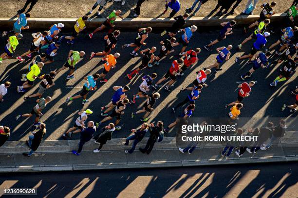 Runners participate in the fortieth edition of the Rotterdam Marathon as they cross the Erasmus Bridge on October 24, 2021. - Netherlands OUT /...