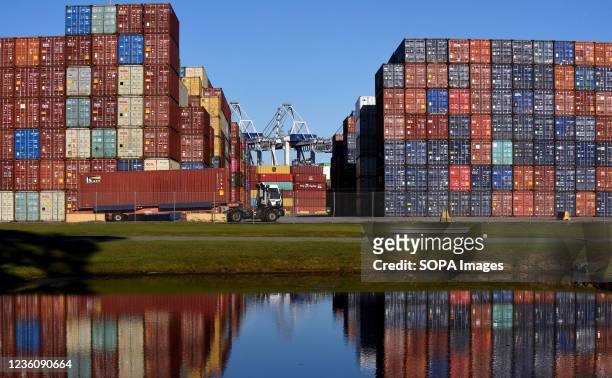 Truck picks up a shipping container at the Port of Savannah in Georgia. The supply chain crisis has created a backlog of nearly 80,000 shipping...