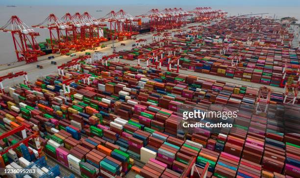 An aerial photo taken on The morning of October 24, 2021 shows the automatic wharf of Shanghai Yangshan Deep Water Port at night in Shanghai, China....