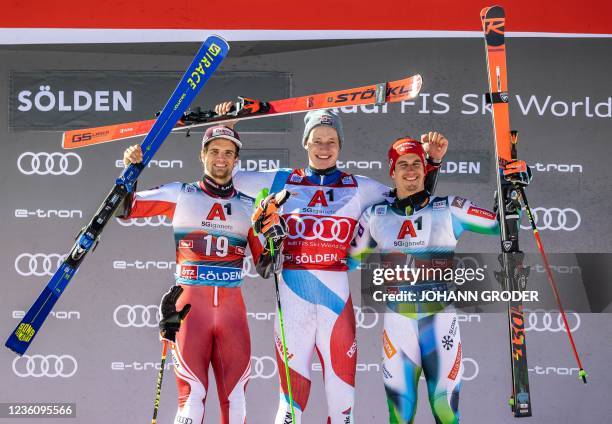 Austria's Roland Leitinger, Switzerland's Marco Odermatt and Slovenia's Zan Kranjec celebrate on the podium after the second run of the men's Giant...