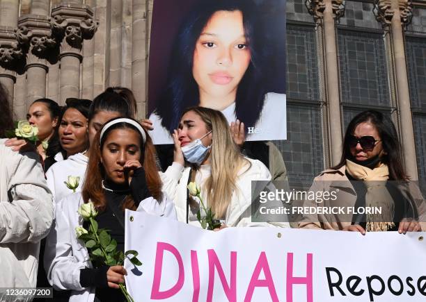 Members of the public hold a banner which reads as "Dinah Rest In Peace" as they participate in a white march in Mulhouse, eastern France, on October...