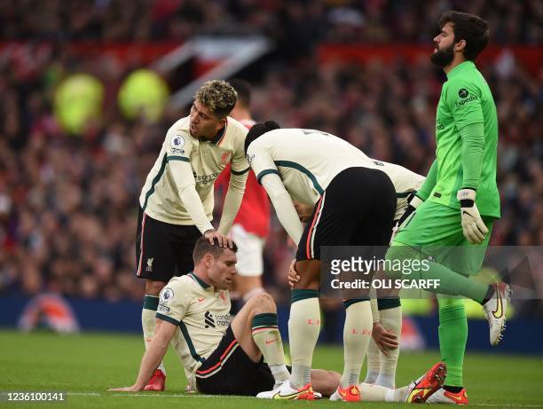 Liverpool's English midfielder James Milner goes down injured during the English Premier League football match between Manchester United and...