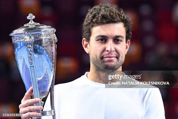 Russia's Aslan Karatsev celebrates with the trophy after winning the men's singles final match against Croatia's Marin Cilic at the VTB Kremlin Cup...
