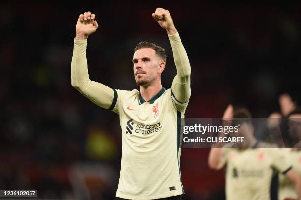 Liverpool's English midfielder Jordan Henderson celebrates on the pitch after the English Premier League football match between Manchester United and...