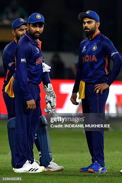 India's Rishabh Pant , Rohit Sharma listen to their captain Virat Kohli during the ICC men's Twenty20 World Cup cricket match between India and...