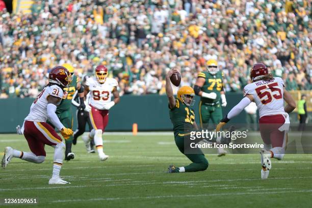 Green Bay Packers quarterback Aaron Rodgers slides for a first down during a game between the Green Bay Packers and the Washington Football Team at...