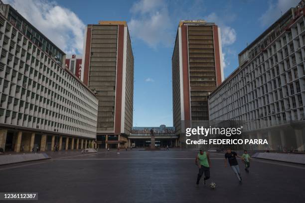 Boys play football at Simon Bolivar Center in Caracas, on October 23, 2021. - Venezuela, now plagued by economic crisis and dotted with shanty towns,...