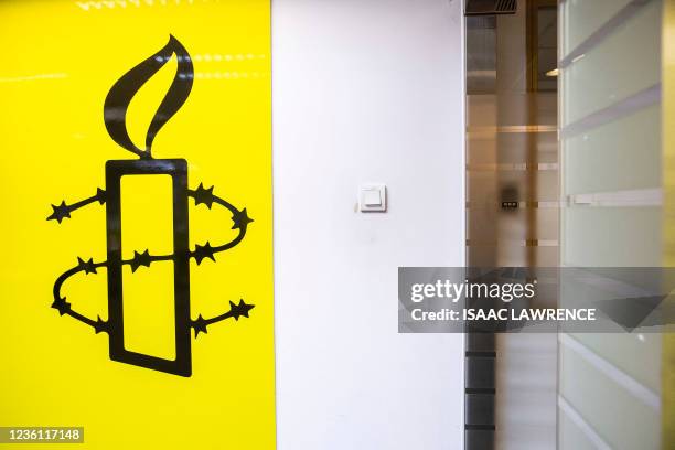 The Amnesty International logo is seen in their office in Hong Kong on October as the Human Rights organisation announces it will be closing its...