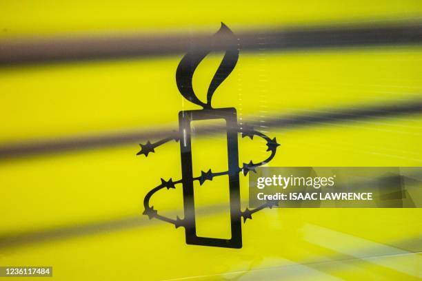 The Amnesty International logo is seen in their office in Hong Kong on October as the Human Rights organisation announces it will be closing its...