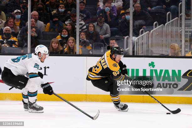 Boston Bruins right wing Karson Kuhlman pursued by San Jose Sharks center Jasper Weatherby during a NHL game between San Jose Sharks and Boston...