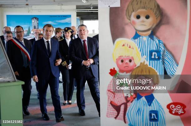 French President Emmanuel Macron , next to Mayor of Montbrison, Christophe Bazile , visits the "Gege" industrial wasteland, site of former French toy...