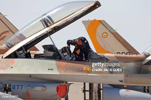 Israeli air force mechanics inspect the cockpit of an F-16 fighter during the "Blue Flag" multinational air defence exercise at the Ovda air force...