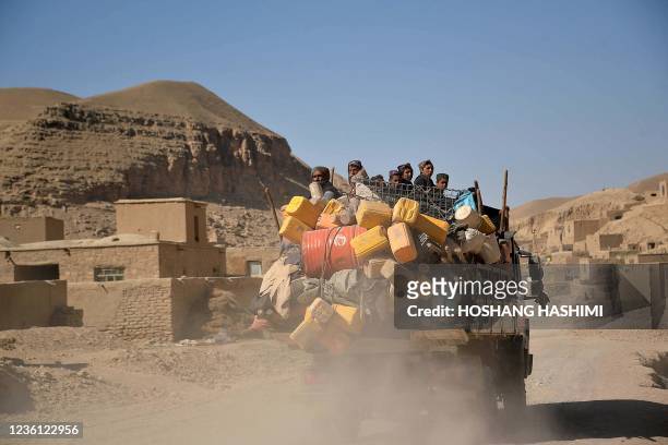 This picture taken on October 17, 2021 shows a family relocating from an area due drought in Moqur district of Badghis province. - Drought stalks the...