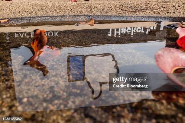 The Facebook logo reflected in a puddle at the company's headquarters in Menlo Park, California, U.S., on Monday, Oct. 25, 2021. Facebook Inc.,...