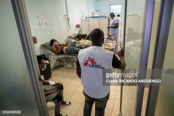 Medical personnel from a Doctors Without Borders medical facility enter the triage area during a general strike and lack of transportation, amid a...