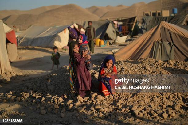 This picture taken on October 14, 2021 shows Asho , a little girl betrothed to a 23-year-old man to whose family was indebted, sitting outside a tent...