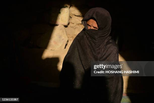 This picture taken on October 14, 2021 shows Gul Bibi, mother of Asho , a little girl betrothed to a 23-year-old man to whose family was indebted,...