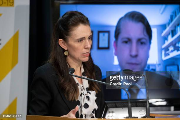 New Zealand Prime Minister Jacinda Ardern speaks as Workplace Relations & Safety Minister Michael Woods attends via a Zoom video call during a...