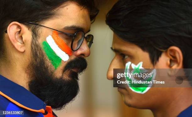 Fans of cricket match paint Indian Flag and Pakistan Flag on the faces at Mulund in Mumbai during India vs Pakistan T20 world cup match, on October...