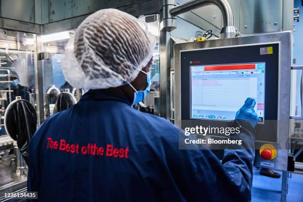 Worker controls filling machinery on the general anesthetics production line during a media tour at the Aspen Pharmacare Holdings Ltd. Plant in...