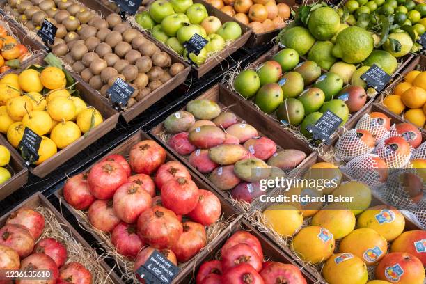 Local grocer 'Bora & Sons', a fruit and veg retailer, displays mangos, pomegranates, kiwis, oranges and other produce outside its high street...