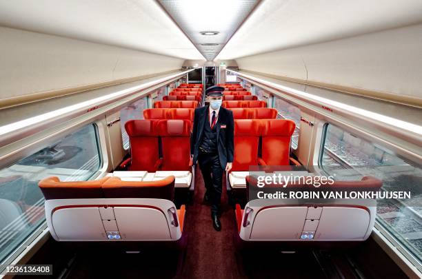 Tickets inspector is pictured inside of the renewed Thalys train at Amsterdam Central railway station, on October 26, 2021. - The new high-speed...