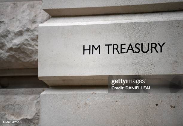 Logo is pictured outside the Treasury building in central London on October 26 on the eve of the government's annual budget announcement. - Britain's...