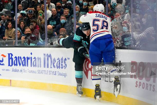 Ryan Donato of the Seattle Kraken and David Savard of the Montreal Canadiens collide during the first period against at Climate Pledge Arena on...