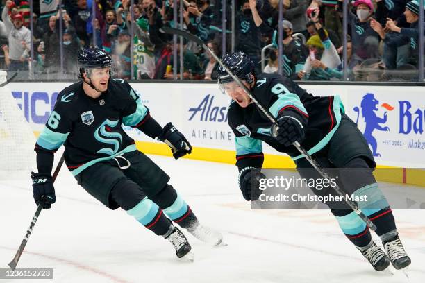 Ryan Donato of the Seattle Kraken celebrates alongside Jared McCann after scoring a goal against the Montreal Canadiens during the third period at...