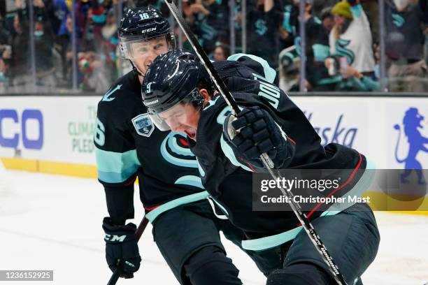 Ryan Donato of the Seattle Kraken celebrates alongside Jared McCann after scoring a goal against the Montreal Canadiens during the third period at...