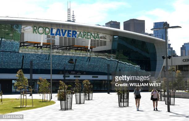 People walk past the main entrance to Rod Laver Arena, home of the Australia Open tennis tournament in Melbourne on October 27 after the Victoria...