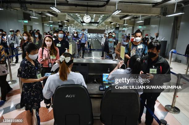 Airport staff pretend to enter Thailand at the new entry lanes at Suvarnabhumi International Airport as they rehearse reopening procedures to welcome...