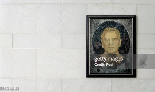 The empty place for a portrait of Germany's Chancellor Angela Merkel is seen next to a portrait of Germany's former Chancellor Gerhard Schroeder in...