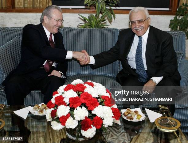 Secretary of Defense Donald Rumsfeld shakes hands with his Algerian counterpart Abdelmalek Guenaizia as they meet at the Defense Ministry in Algiers...