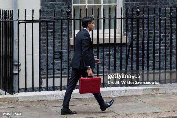 Chancellor of the Exchequer Rishi Sunak walks with the Budget box outside 11 Downing Street in central London ahead of the announcement of the Autumn...