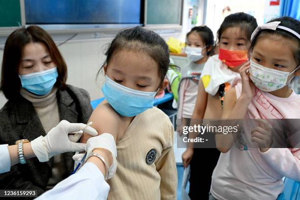 Child receives the Covid-19 coronavirus vaccine at a school in Handan, in China's northern Hebi province on October 27 after the city began...