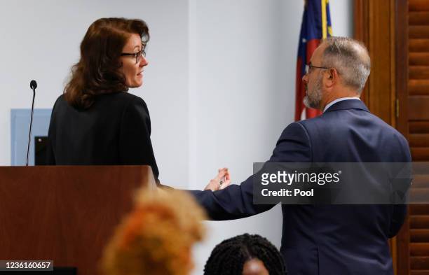 Defense attorney Jason Sheffield speaks with prosecutor Linda Dunikoski during the jury selection in the trial of the men charged with killing Ahmaud...