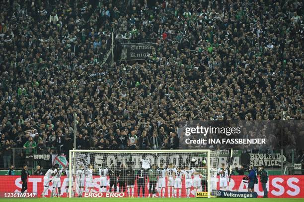 Moenchengladbach's players celebrate with their fans after their 5-0 win after the German Cup 2nd round football match Borussia Moenchengladbach v FC...