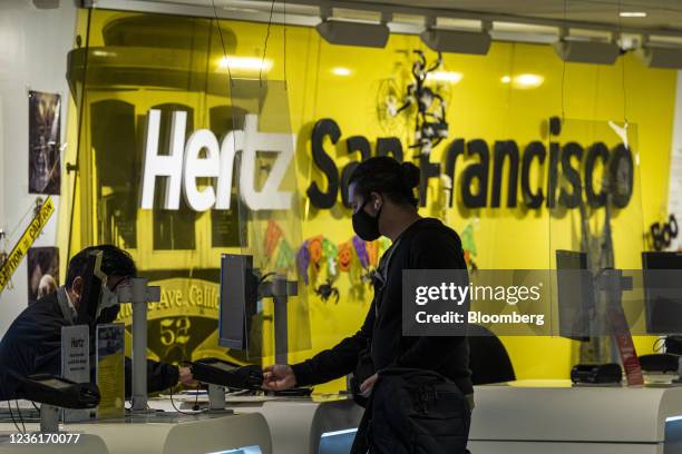 Customer checks in at the Hertz rental counter at San Francisco International Airport in San Francisco, California, U.S., on Wednesday, Oct. 27,...