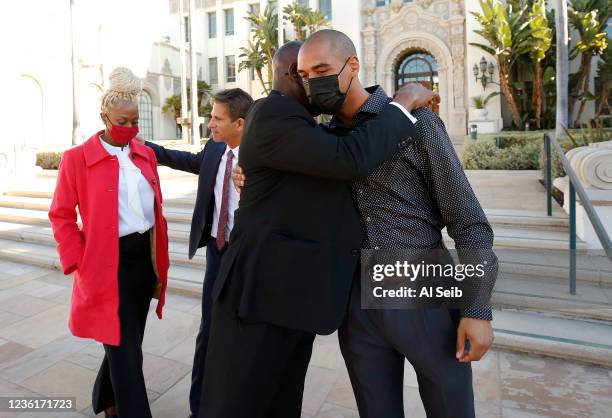 Lakisha Swift, left, is comforted by attorney Bradley Gage, left as her boyfriend Joseph Nett, right, is hugged by attorney Benjamin Crump after...