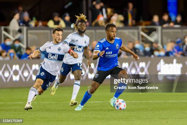 San Jose Earthquakes attacker Jeremy Ebobisse leads the ball across the field with Vancouver Whitecaps defender Cristian Gutierrez and Vancouver...