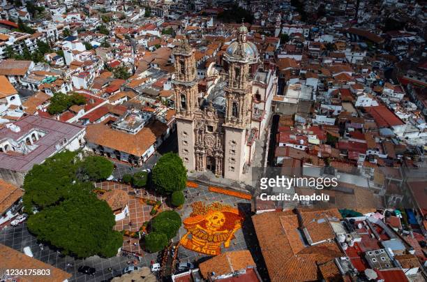 An aerial view of the figure of a Catrina skull made with 18,000 Cempasuchil flowers is on display at the Church of Santa Prisca as part of Day of...