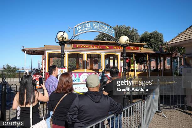 Tourists wait in a line to get on San Francisco's famous cable car on Hyde Street in San Francisco, California, United States on October 27, 2021.
