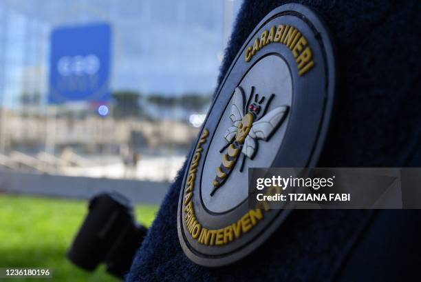 The badge of a Carabinieri police officer is pictured as he stands guard outside the convention center "La Nuvola" on October 28, 2021 in the EUR...